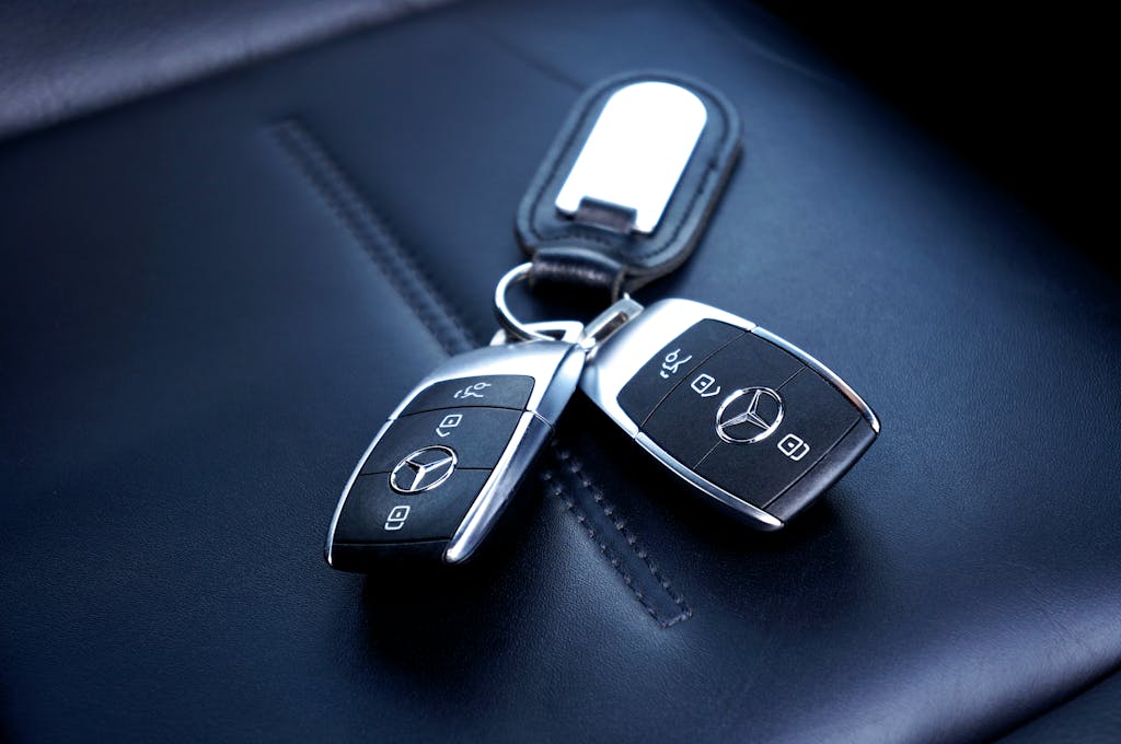 Thornton Locksmith, Two Mercedes Benz car keys resting on a luxurious leather seat, showcasing elegance and design.